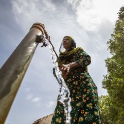 woman at water pump