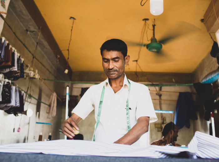 Refugee man tailors clothes