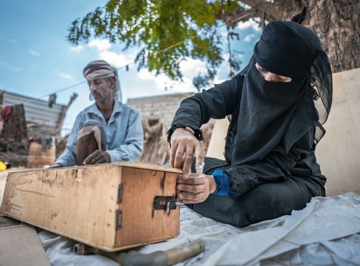 Nazrah Mohsen and her husband building a beehive