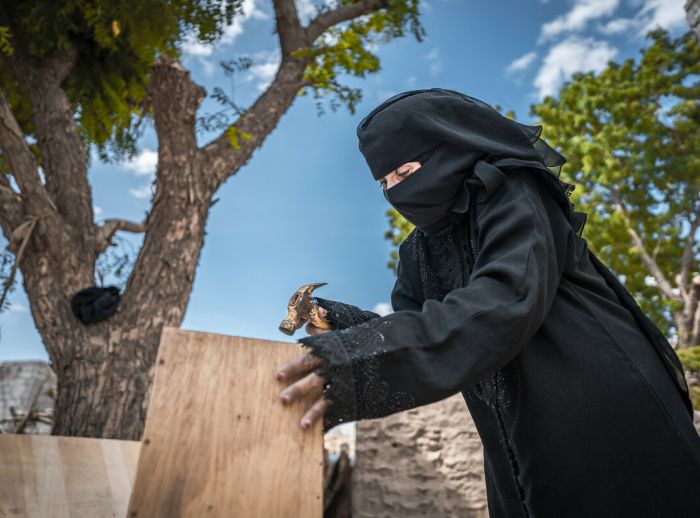 Nazrah Mohsen building a beehive