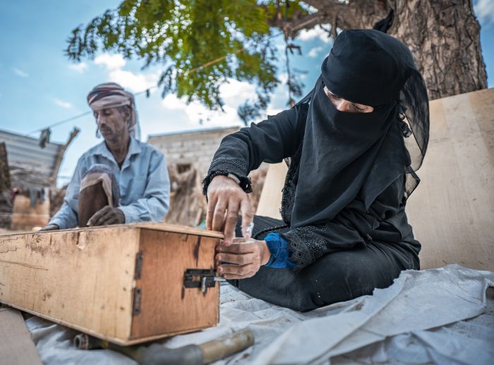 women building beehive