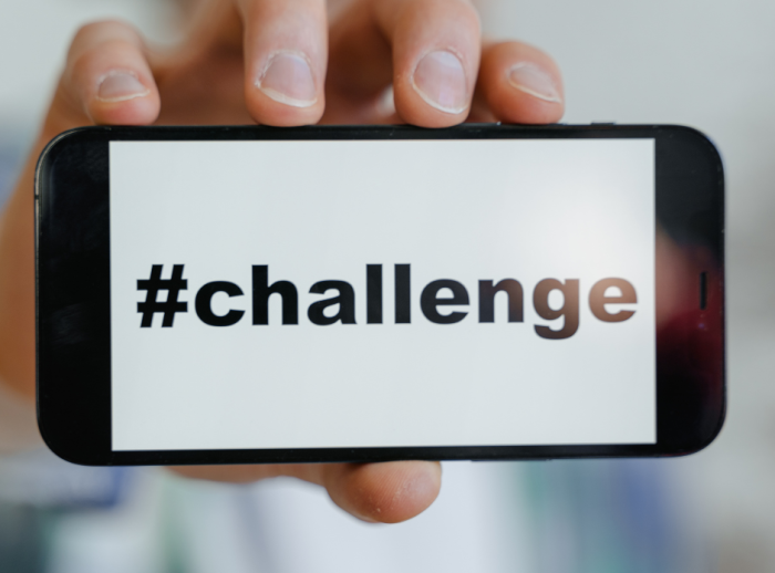 A mobile phone with the word #challenge on the screen