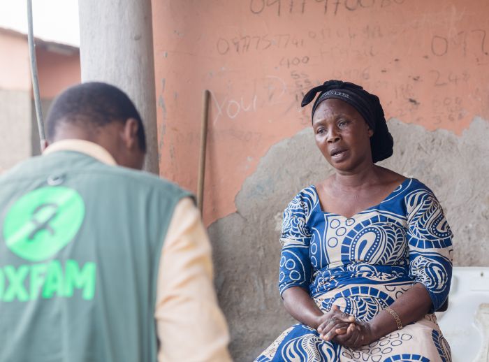 Woman in Zambia talking with an Oxfam member.