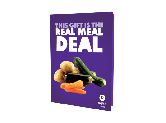 image of our unwrapped card "This gift is the Real Meal Deal" featuring vegetables on a purple background.