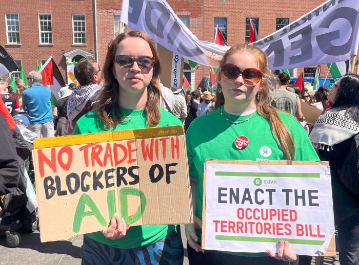 Oxfam Campaigners at Dublin's national march for Palestine with banners "no trade with blockers of aid" and "Enact the occupied territories bill""