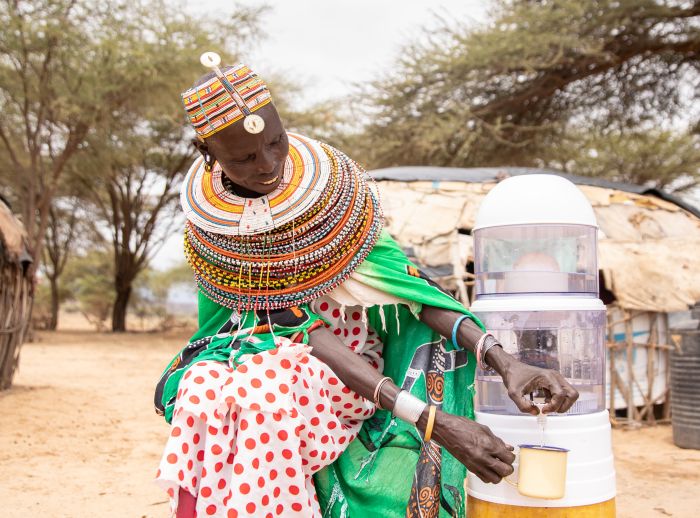 Diboya Maro pours clean drinking water from a filter at her rural home.