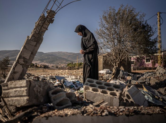 Ruba Chamas walks through the ruins of her bombed home.