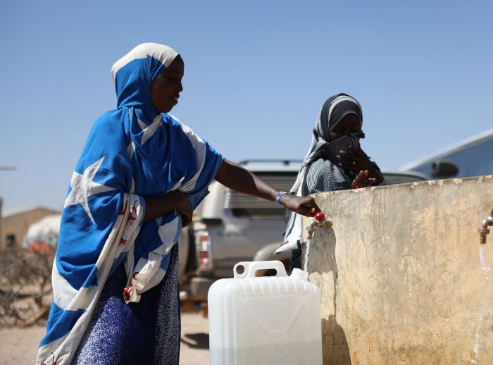 Amina Sahardid collects water at an Oxfam-supported tap in Boocame, Sool Region.