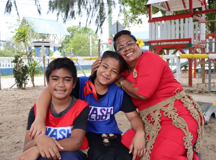 Protrait of Nuka Talanoa, the principal of the Pangai Primary School in rural Ha'apai island, Tonga. Her students, Christopher and Nanise, are members of the WASH club, teaching younger students proper handwashing and water conservation techniques. 