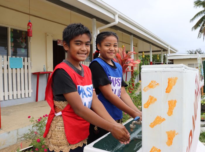 Nine year old Christopher and Nanise, washing their hands in their primary school