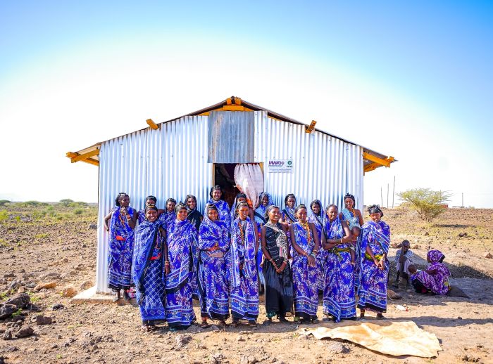 The women of Segei Machesa self help group stand in front of their newly constructed social hall.