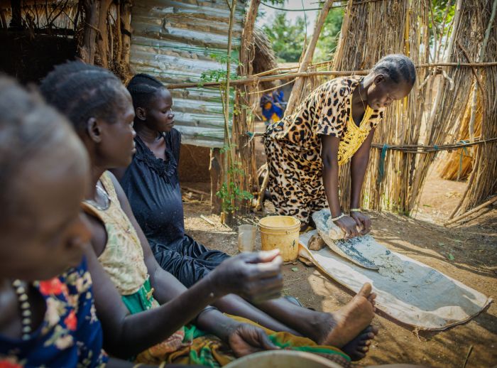Ngakutoth Biel making food with the ladies of her community