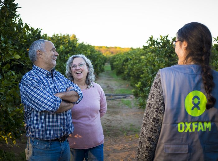 María and Francesc in their citrus plantation in Valencia with an Oxfam Intermón staff member.