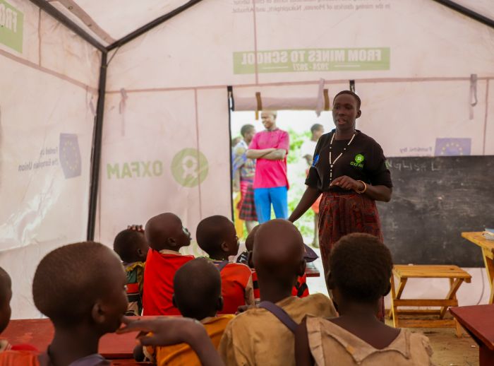 Adome Mary teaching kids at the mobile learning center
