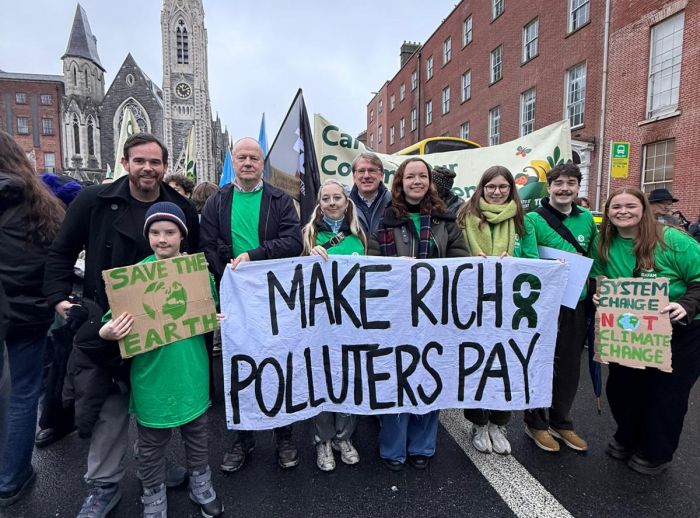 Oxfam Ireland Group at the National Climate Demonstration in Dublin holding a banner "Make Rish Polluter Pay" & "Save the Earth". 