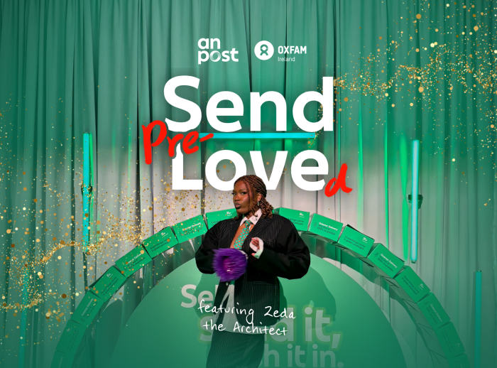 Stylist Zeda the Architect stands in front of a green background with 'send Pre-Loved' writing.