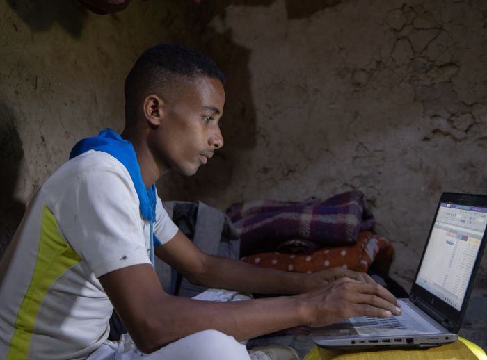 Munadhel studying with his laptop