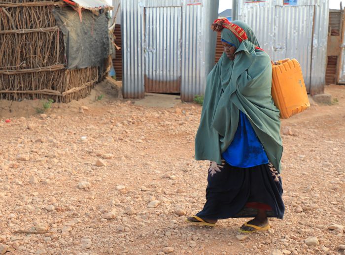 Saada Abdulahi carrying jerrycan of water.