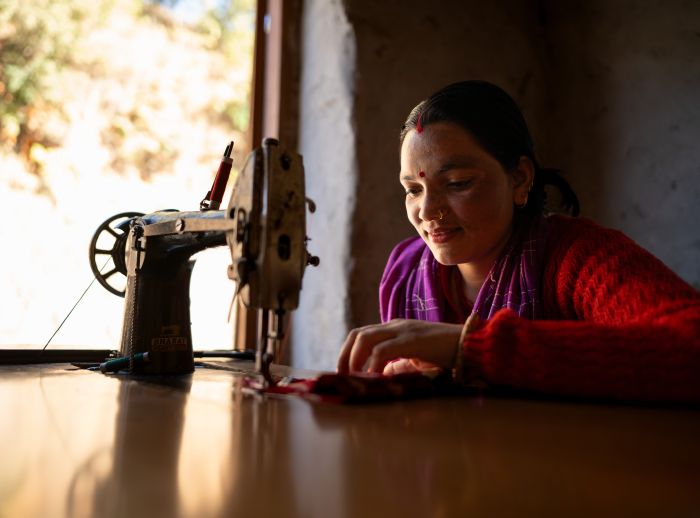Reshma Kumari Nepali works on her sewing machine in her shop.