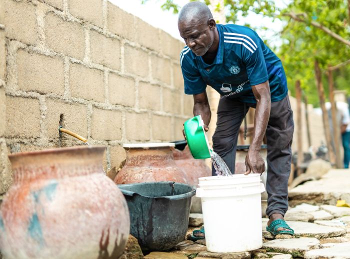 Ibrahim Musa helping with the house chores.