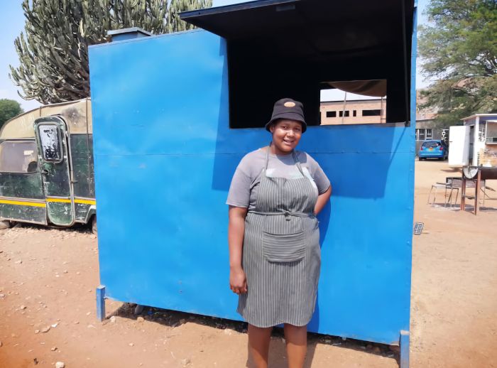 Mamoyo in front of her caravan