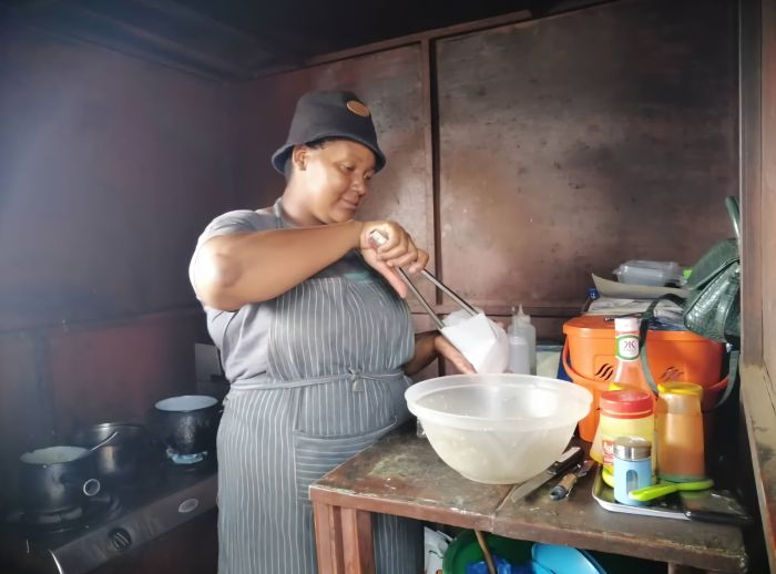 Mamoyo preparing meals in her caravan 