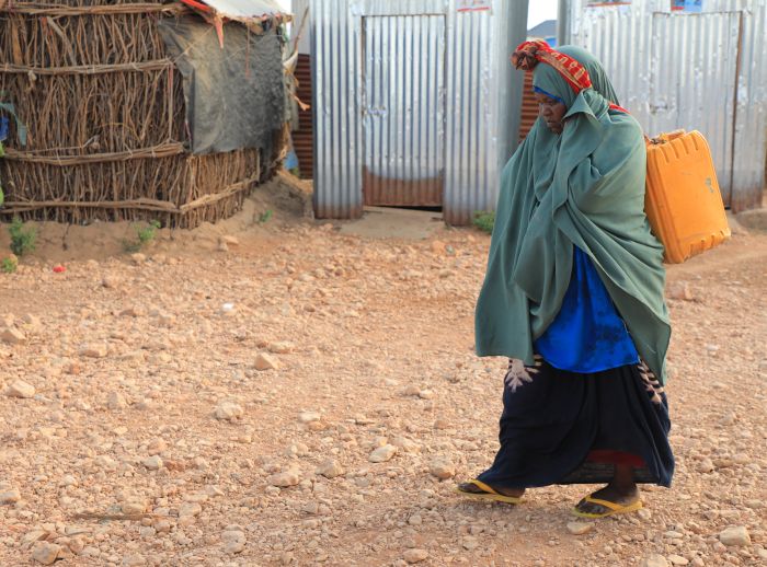 Saada Abdulahi carrying jerrycan of water.