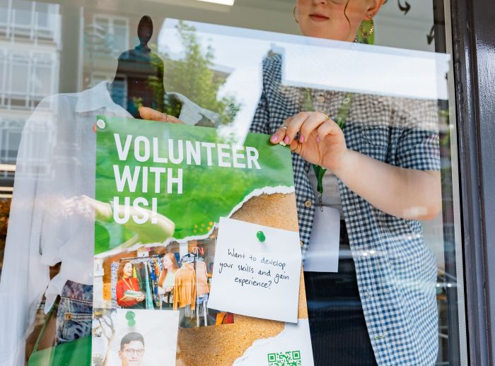 Volunteer promoting recruitment in store