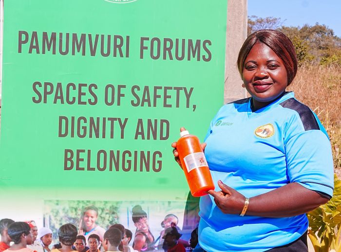 Young woman standing and holding a product she helped produce