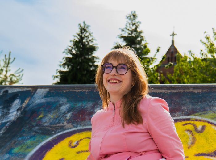 Comedian Bláithín de Burca sitting at a skate park.