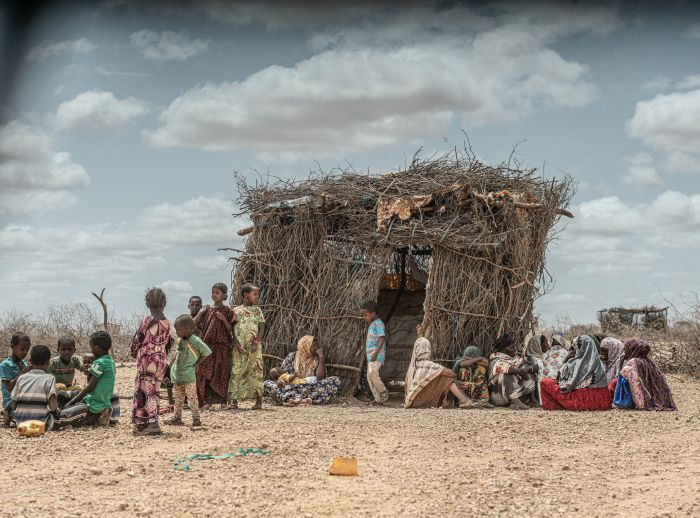 Children in front of a straw hut