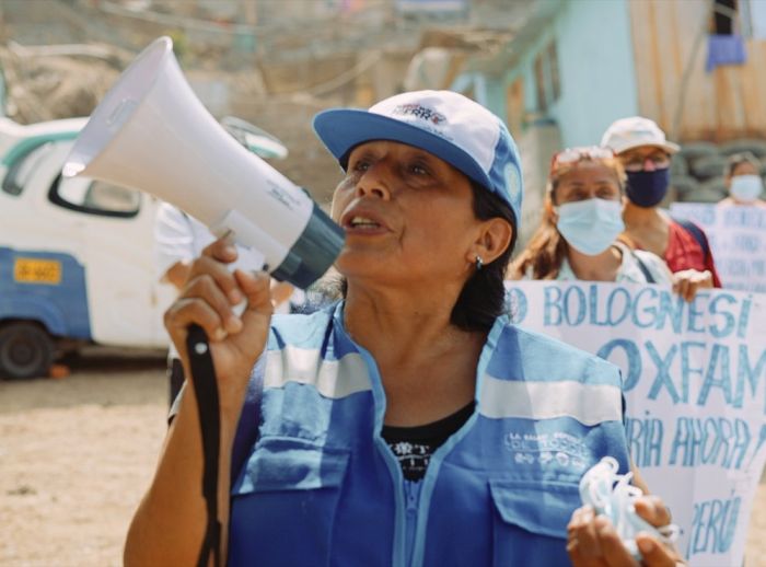 Janet Fuentes leads a march in her community of Santa Rosa in Lima, Peru.