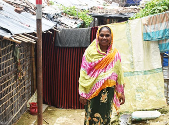 Smiling woman in front of her shelter