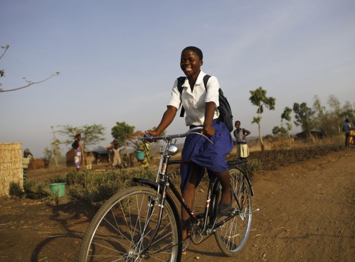 Young Grace on her new Oxfam bicycle. Photo: Corinna Kern/Oxfam