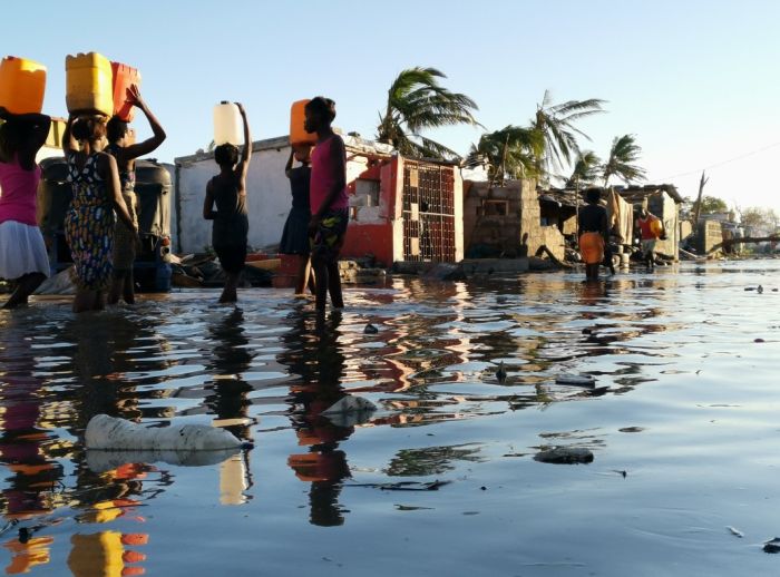 Cyclone survivors walk through floods
