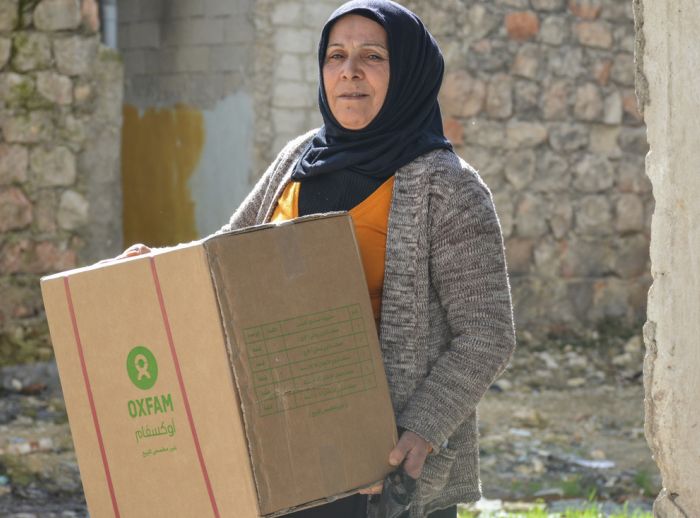 Woman carries a winter survival box