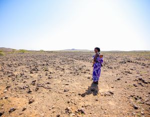 Gumato Bagajo walks while carrying her child in Segel Village.