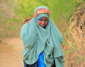 Saada Abdulahi carrying jerrycan of water.