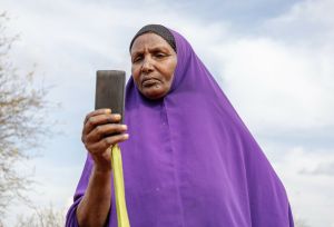 Ebla Hussein Ahmed reading a message from her mobile phone