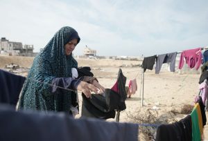 Women is doing the laundry next to her tent in Al Mawasi