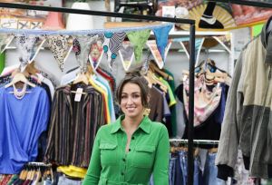 Fiona, store manager standing in the middle of the vintage section of the Oxfam Holywood Superstore.