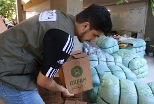 Oxfam's partner staff distributing hygiene management kits