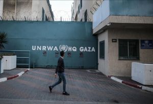 Picture of UNRWA HQ's gate in Gaza. A person was walking by when the picture was taken.