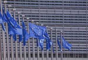 European Commission building with European flags in a row