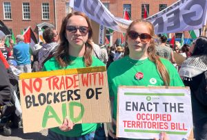 Oxfam Campaigners at Dublin's national march for Palestine with banners "no trade with blockers of aid" and "Enact the occupied territories bill""
