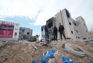 Gaza Crisis, 3 men standing waiting for aids. 