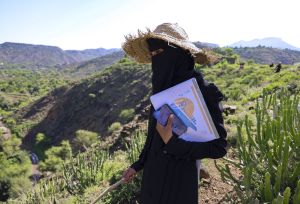 Nahla Abdo, 25, mobile technician, with phone and guidebook in Al-Ma’afer, Taiz.