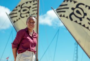 Cynthia Houniuhi stands in front of the Uto ni Yalo boat at the Pacific Island Forum in Tonga.