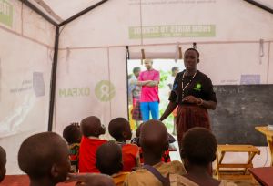 Adome Mary teaching kids at the mobile learning center