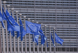 European Commission building with European flags in a row